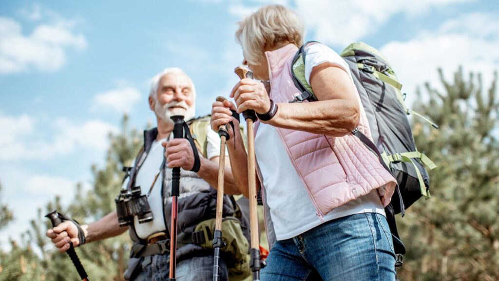 Ein älteres Paar beim Wandern. (c) AdobeStock